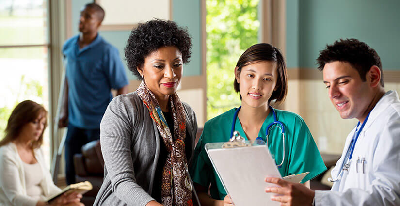 Oncologist going over resources with oncology patient and nurse navigator